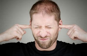 guy plugging his ears